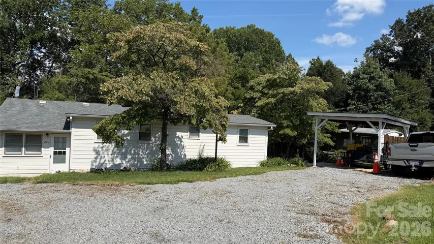 from driveway with carport, off-street parking and mudroom entrance.