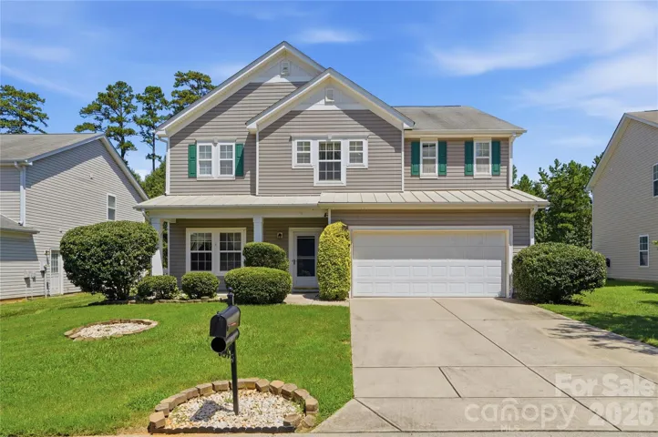 Craftsman-style curb appeal in St. John's Forest, with a rocking-chair front porch made for morning coffee and waving to neighbors
