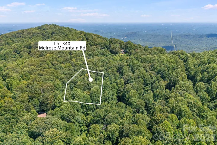 Aerial view showcasing this 1.13-acre wooded homesite surrounded by the natural beauty and rolling terrain of Melrose Mountain.