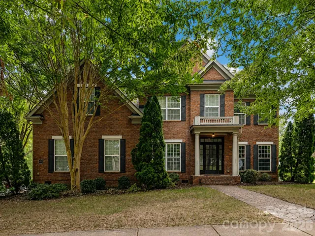 Beautiful brick home in Vermillion surrounded by mature trees, offering timeless curb appeal and a welcoming front entry.