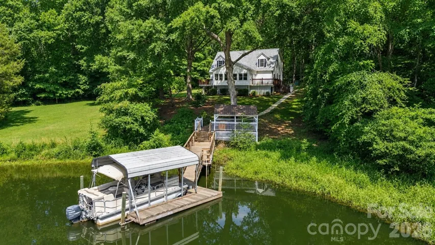 Private waterfront retreat with deep water covered dock.