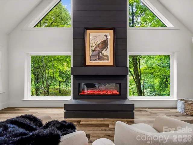Cozy up by the fireplace during the winter months and watch the snow fall through the expansive windows.