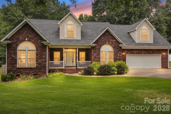Beautiful partial brick home on 0.80 acres with attached 2 car garage and detached 1.5 car garage/workshop.