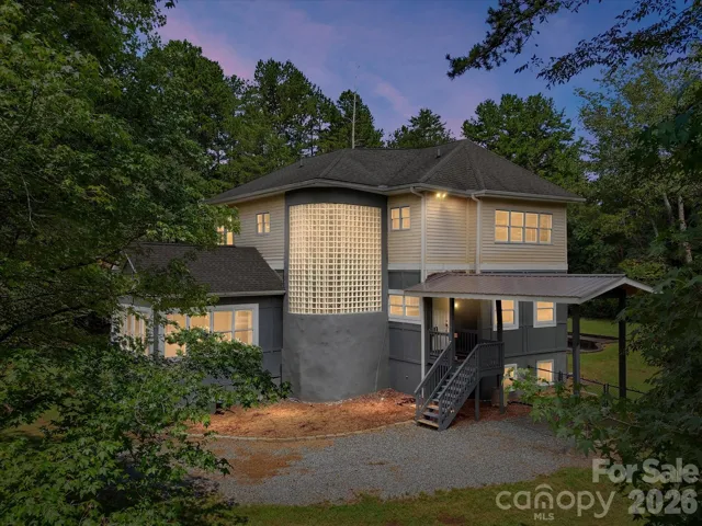 Tucked away on 10.05 private acres in Davidson, NC, this unique home offers a secluded wooded setting, distinctive architecture, and incredible potential.