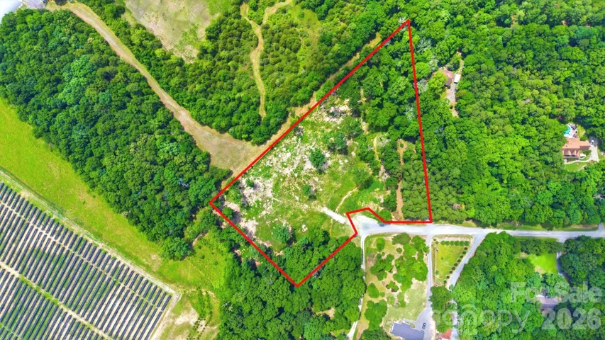 Aerial view of the 4.08-acre lot with approximate boundary lines outlined.