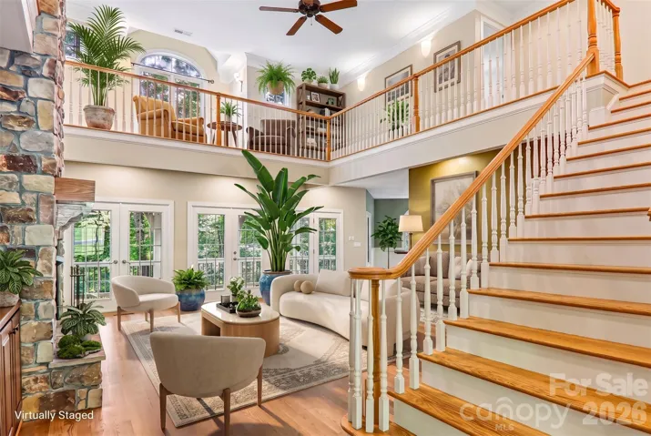 Virtually staged great room with natural light and tall ceilings