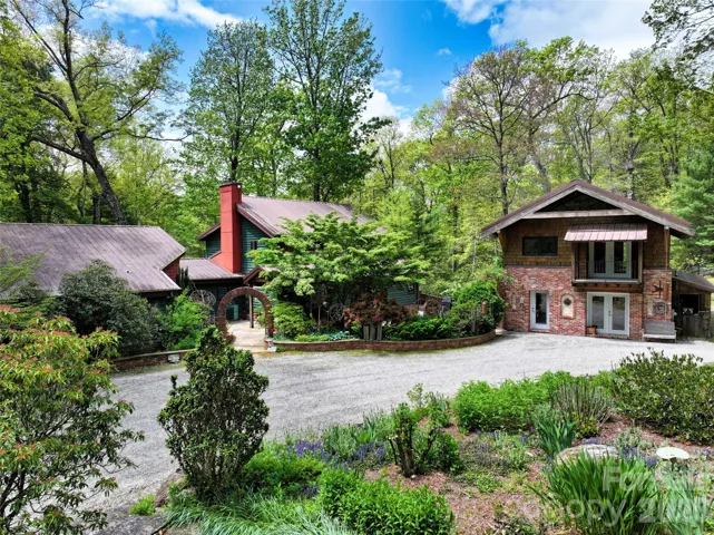 Main Home with circle drive and lush landscaping