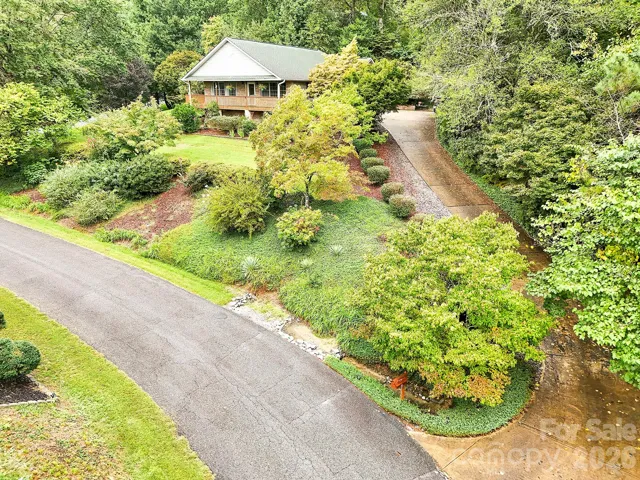 Elevated front view, mature landscaping.
