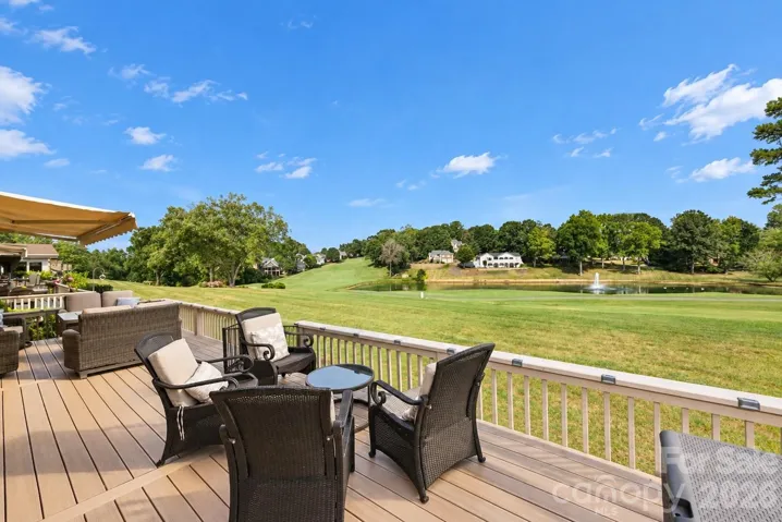 New and enlarged deck overlooking the 10th fairway and pond with fountain.
