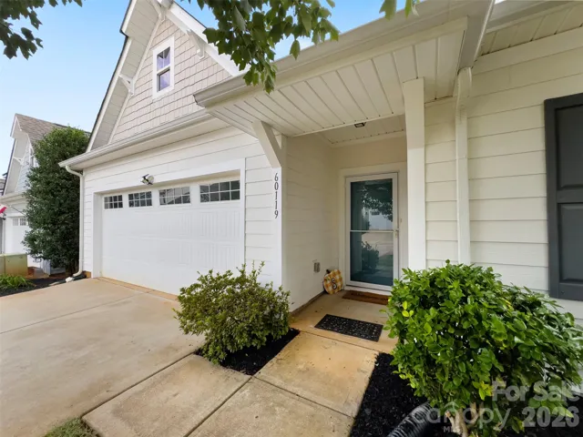 Front of home 2 car garage covered stoop