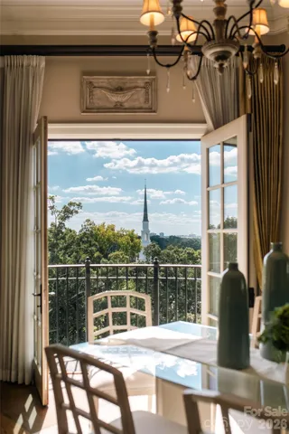 From the dining area's Juliet balcony, eye level with the church steeple above the tree canopy