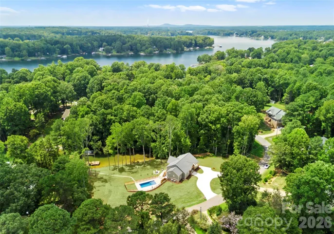Set among mature trees, the home brings together a private pool, generous lawn, and Lake Norman waterfront in one setting.