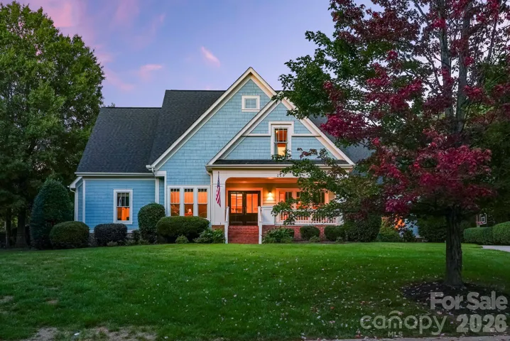 Nestled on .84 acres in The Point experience refined Lake Norman living