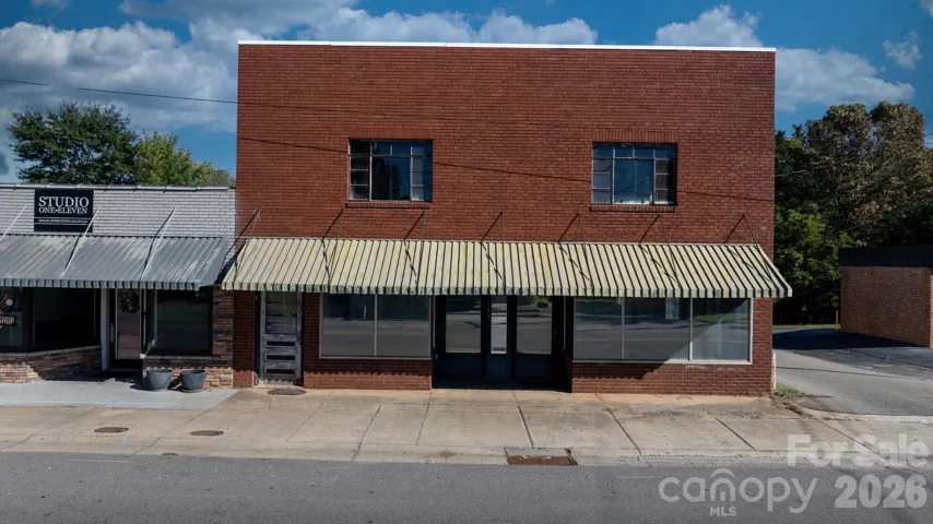 Front(Brick two story part only)- unit can have two retail spaces and door to left is to upstairs.