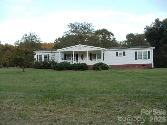 3.51 Acres with a Shop, Double Carport, and multiple stables barn!