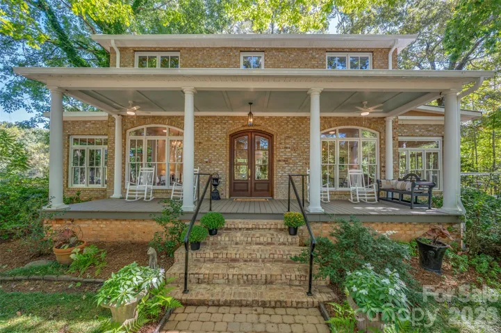 Impressive Greek Revival Home nestled in a canopy of trees with views toward the front pasture.  Sit on your porch and take it all in!