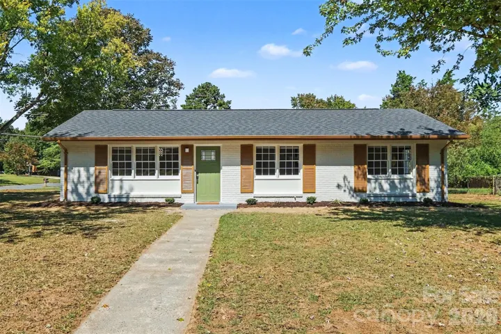 Front Exterior: Freshly painted exterior featuring a new roof, gutters, updated front door, and manicured front lawn.