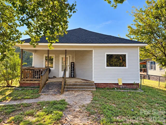 Spacious front porch with both a ramp and stairs for access