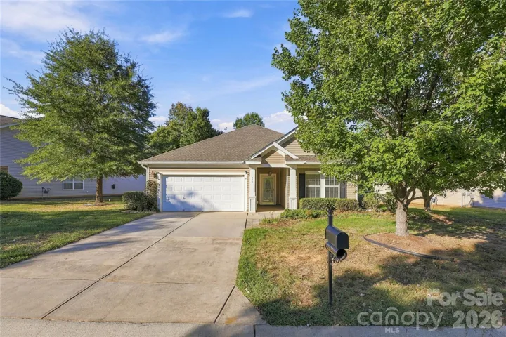 Welcome home! A charming ranch with mature trees, a two-car garage, and wonderful curb appeal.
