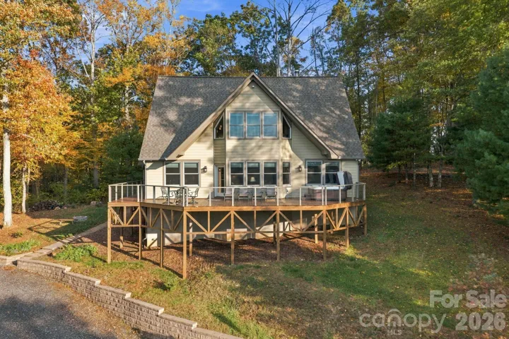 Front of the home with a new stained wrap around porch and hot tub