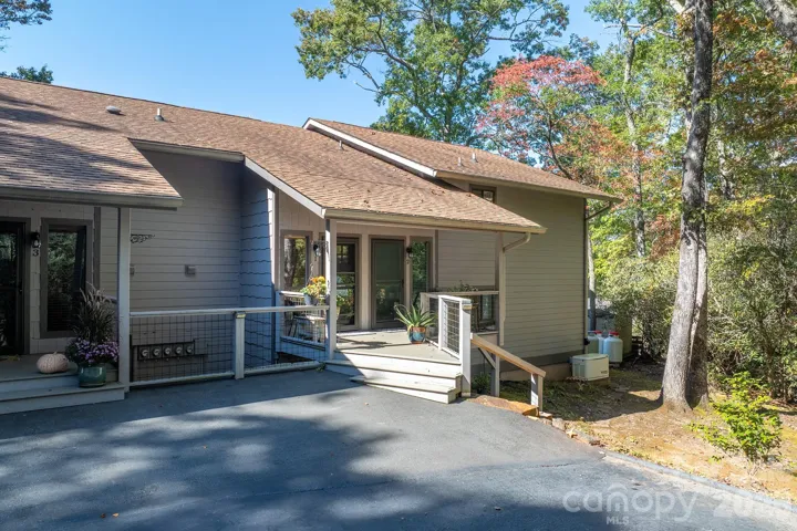 Beautifully landscaped entrance with mature trees providing shade and a peaceful mountain atmosphere