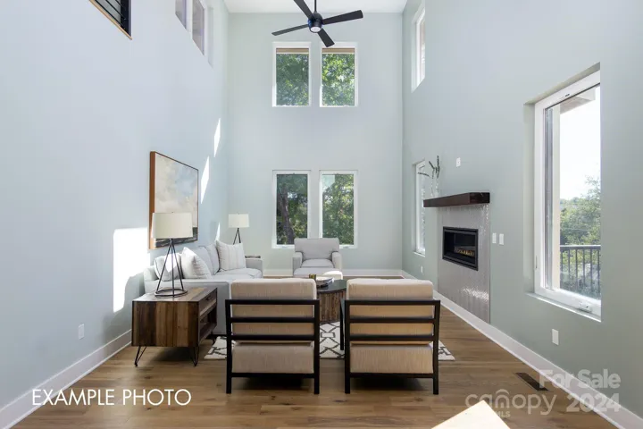 Example photo. Two-story great room brings in natural light and opens us the space.