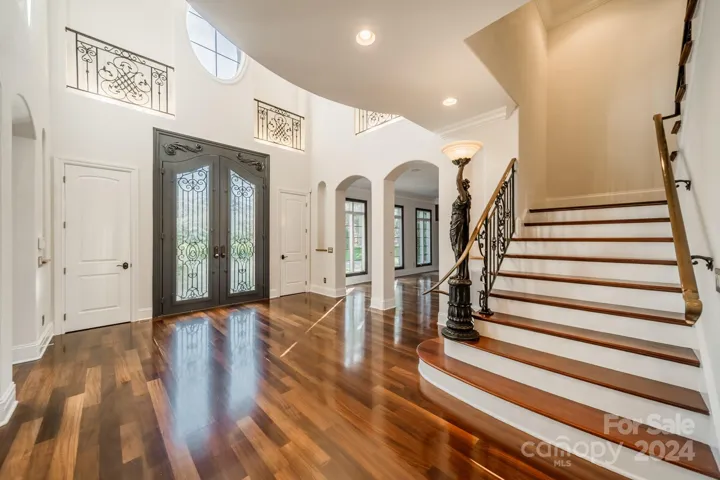 Bright, freshly painted grand 2-story foyer. Double iron doors. All doors freshly painted. 3 floor elevator to the left (not pictured).