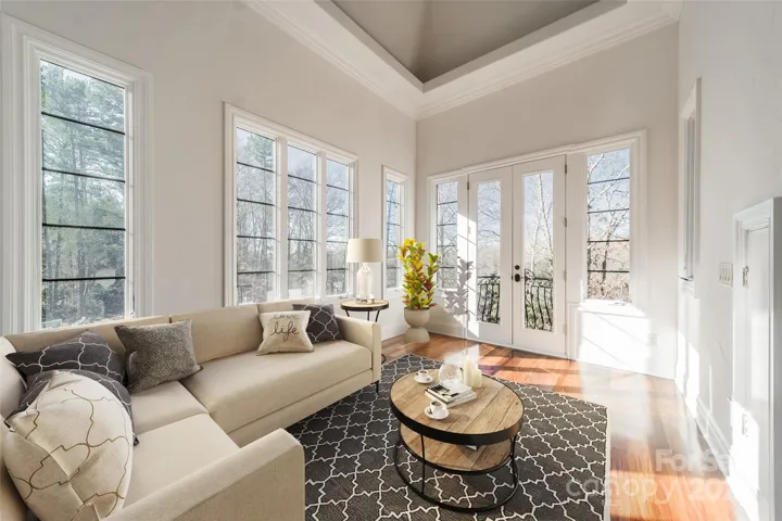 Primary bedroom sitting area with Juliet Balcony.  Freshly painted. (Virtually staged.)