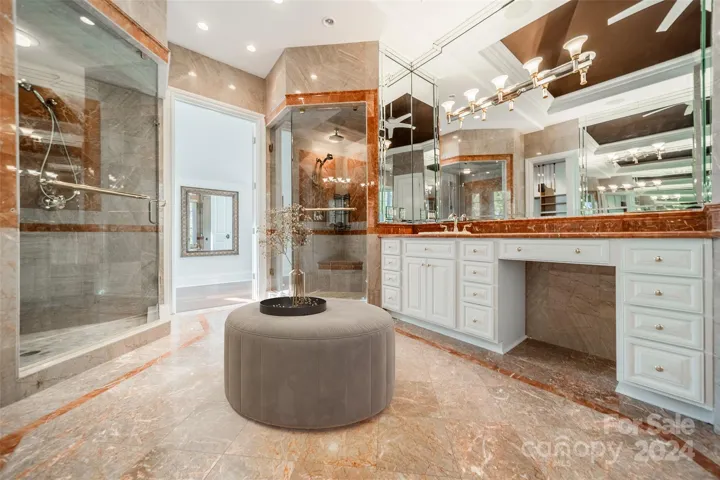 Primary bathroom: dual steam showers, separate vanities, soaker jacuzzi tub.