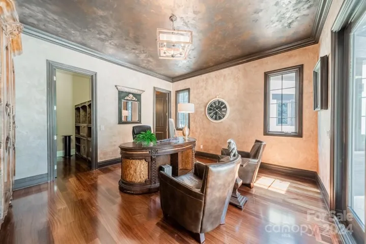 Main Floor: Second primary bedroom and en-suite full bathroom with separate dual vanities and sliding glass door to patio area. Also can be used as an office with views of the private terrace and pool.