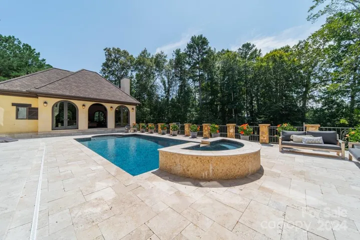 Travertine tile patio. Saltwater pool. Hot tub with fountain into the pool.