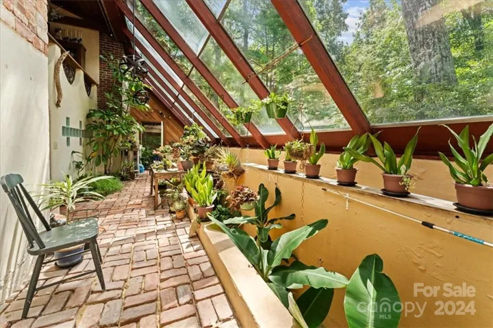 Attached greenhouse with a passive solar heat design.