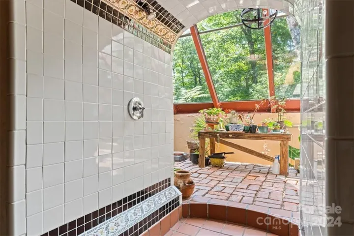 Custom tile shower leads to sauna.