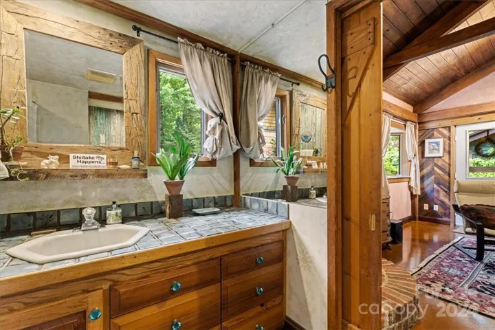 Bathroom (1) in main house with custom, hand built, pocket door, off of the main living room.