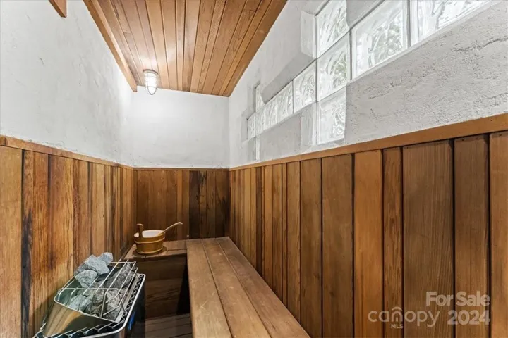 Sauna in main house just off of the greenhouse with attached custom tile shower.