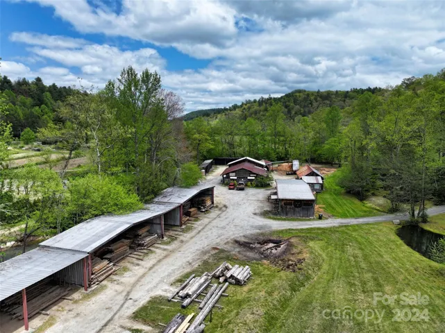Outbuildings by the river and field