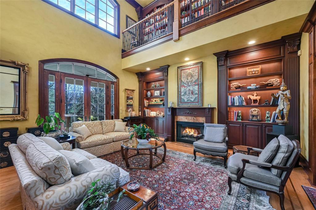 Two floors of light and bookcases surrounding the living area