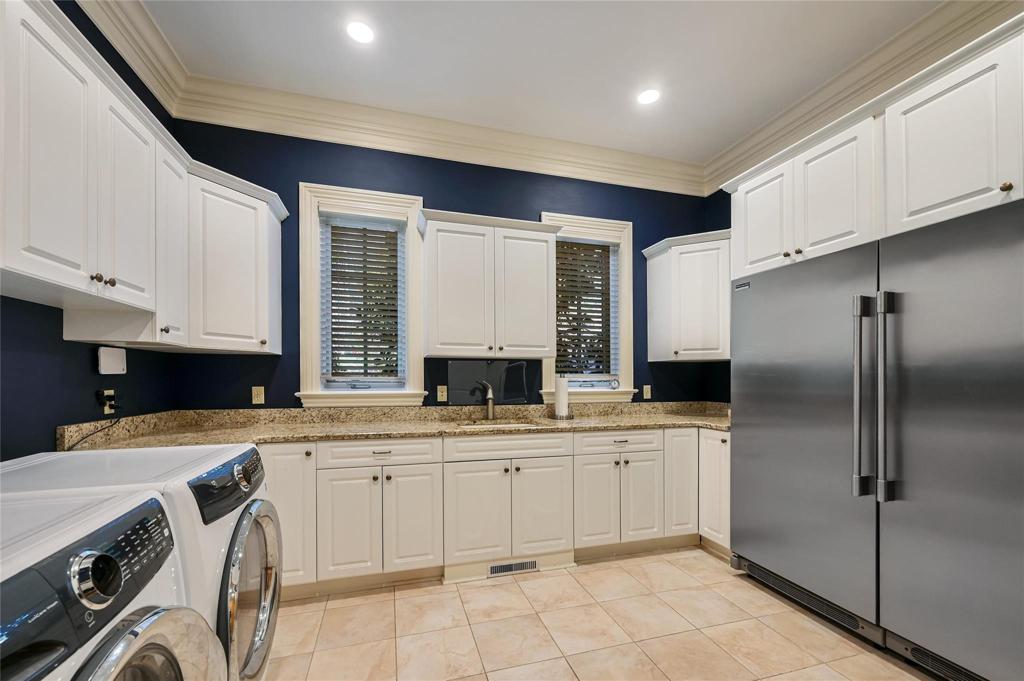 Large laundry room on main level with newer w/d and refrigerator, freezer.