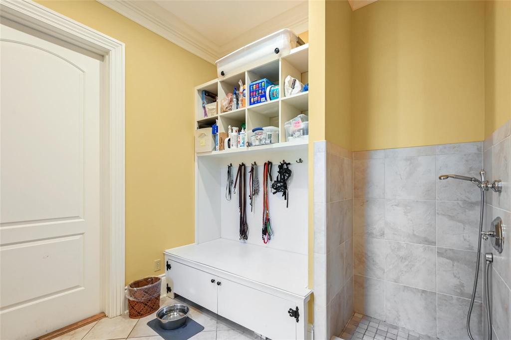 Dog bath on main level in back hallway leading to garage