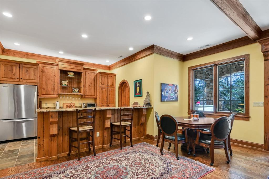 Lower kitchen with refrigerator, sink and wine cellar