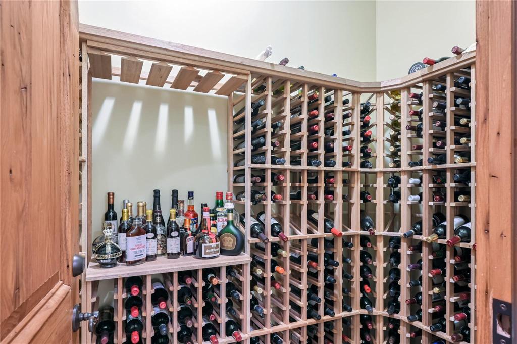 Wine cellar off of lower kitchen with newer wine room cooler and humidifier.