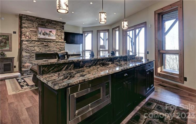 Island in the bar area with a microwave and under-counter refrigerator