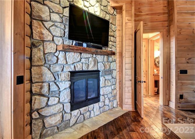 Propane gas log fireplace in the primary bedroom