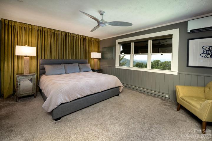 Spacious primary bedroom has mountain views
