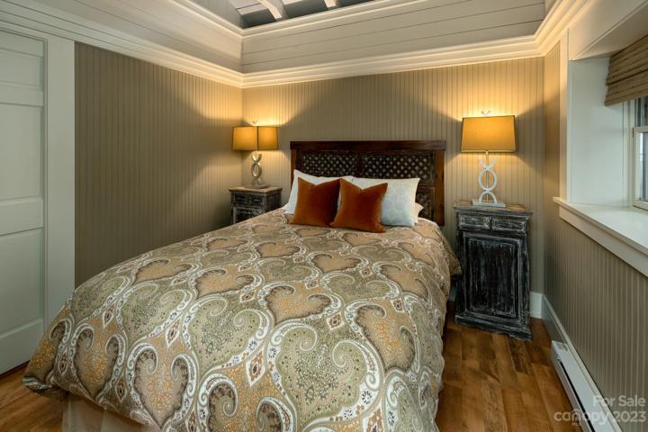 Beautiful bedroom with wood-beamed vaulted ceilings