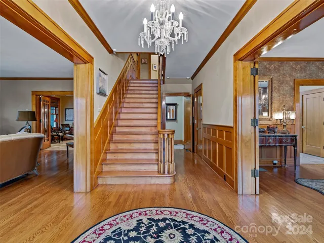 Class. Craftsmanship. Chandeliers. All capture the historic timeless essence. The coat closet in this foyer (further ahead on the right) holds the hub for this home's contemporary sound system.