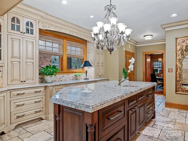 ...a walk-in pantry through the door on the left, while the swinging door straight ahead leads conveniently to the formal dining room...