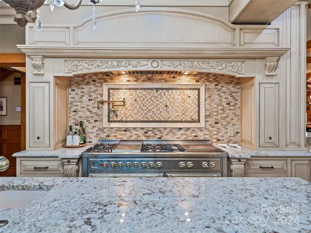 ...such as the tumbled marble tile, the top-of-the-line appliances (including a warming drawer), the meticulously detailed corbels and cabinetry...