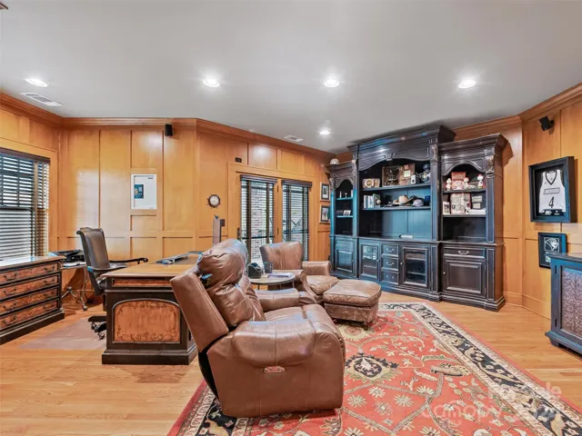 This paneled private office (note the beige wall safe) offers the option for business (or leisure time) to continue outside through those glass doors...
