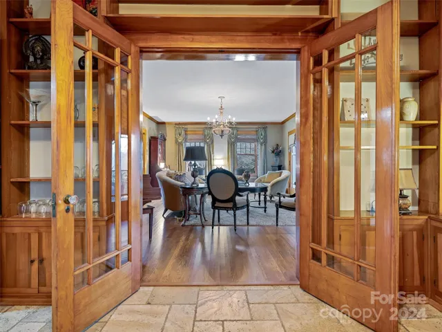 From the formal living room, these show stopping glass French doors invite you to spend some time in this Bar...